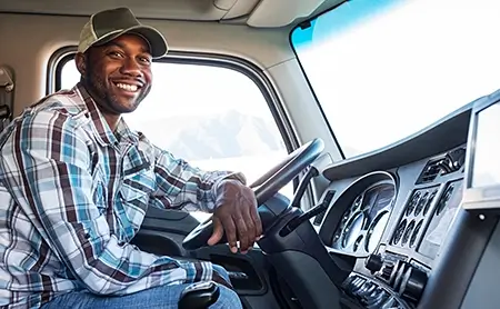 African-American driver behind the wheel of a commercial truck