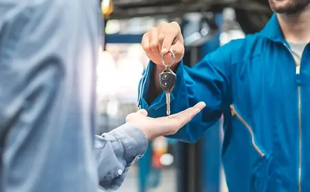 Driver handing keys to driver supervisor